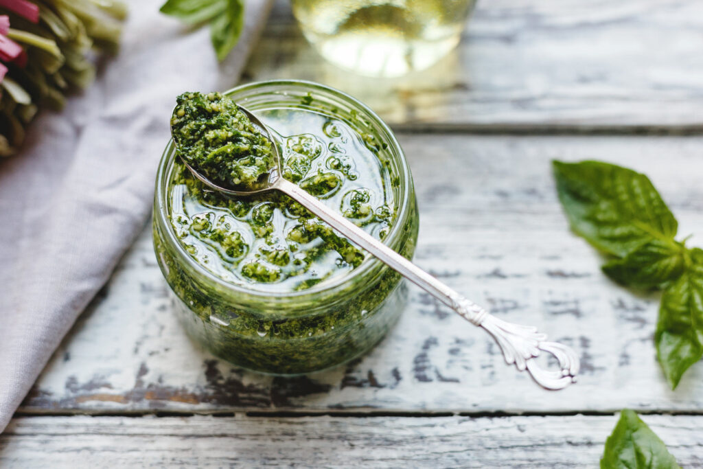 jar of pesto on wood table