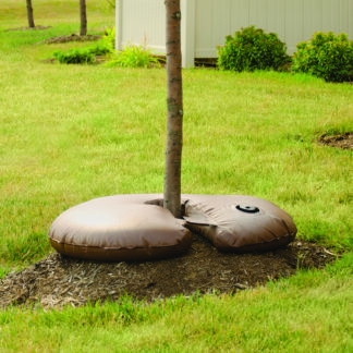 Donut shaped brown bag filled with water surrounding a tree trunk